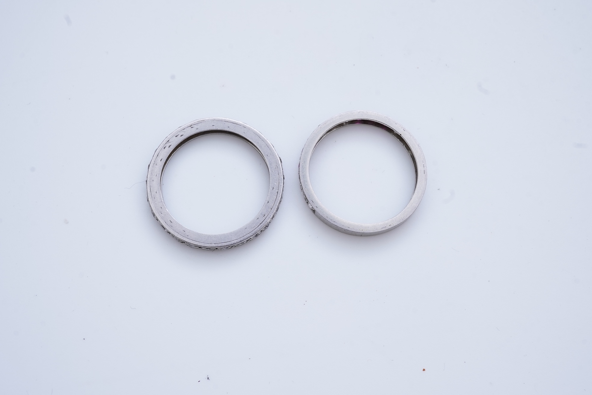 A diamond eternity ring and a ruby and diamond half eternity ring, mid 20th century